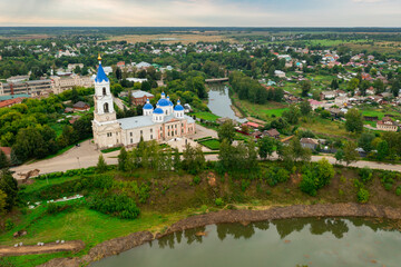 Cathedral with blue domes and belfry decorated with clock on bank of Kashinka river in ancient township of Kashin in Tver Oblast of Russia
