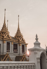 Asian white temple with gold ornaments in Thailand. Asian cathedral on the sunset. High quality photo