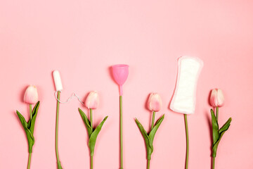 Tampons, menstrual cup and sanitary pads like tulip flowers on pink background. - obrazy, fototapety, plakaty