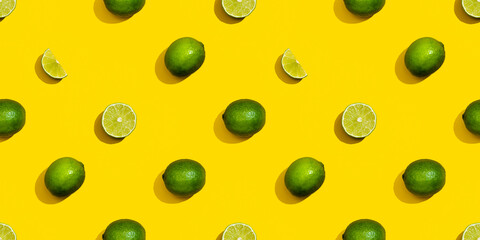 Seamless pattern from limes on a yellow background. Diet and healthy eating