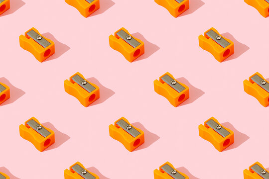 Pencil sharpener pattern on a pink background.