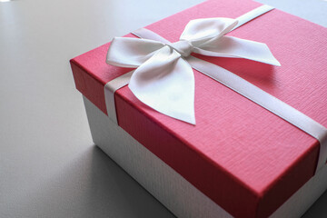 Valentine present. Gift box and red ribbon for romantic couple.Gift box and ribbon with tag for valentine present