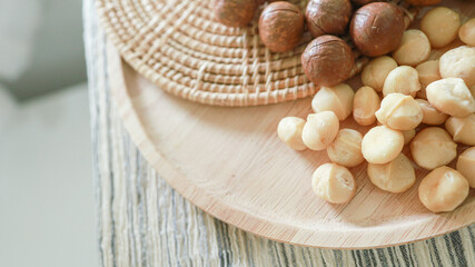 Fototapeta na wymiar Organic Macadamia nut. macadamia nuts are cracked and baked to taste extremely delicious superfood fresh natural shelled unsalted raw macadamia and healthy food concept