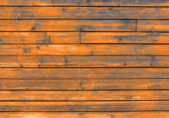 Hardwood plank wall with digital orange-painted, old hardwood board.