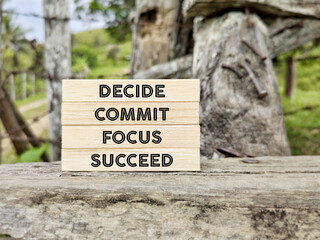 Inspirational and motivational concept - decide commit focus succeed text background.