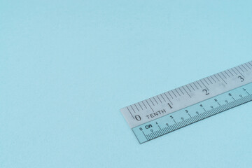 Plastic ruler on light blue background.