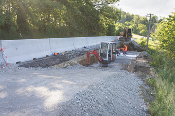 Workman working on new asphalt. Laying the next layer of asphalt in the construction of a new road....