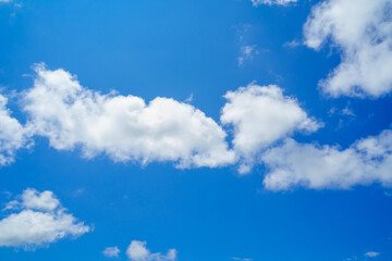 Group of white clouds against blue sky. Cloudscape. 