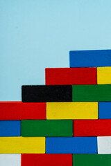 Stack of colorful wooden cuboid shape perfect for background.