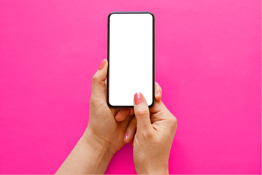Mobile phone with empty white screen in hands on pink background