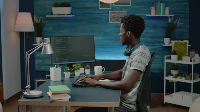 Adult programming web codes on cybersecurity interface. Man programming software codes on computer and typing program information for digital server development. Coder using website firewall system