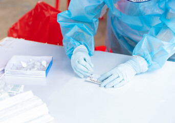 Woman using a rapid antigen test kit.