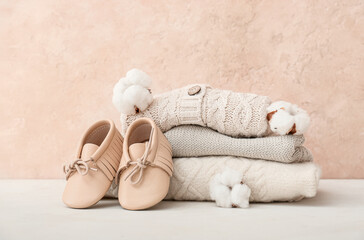 Stylish baby clothes on color background