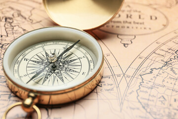 Fototapeta na wymiar Old compass on vintage world map