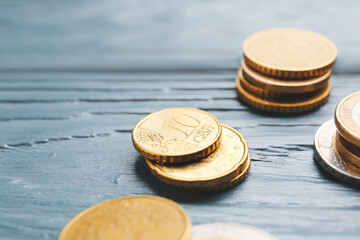 Golden coins on grey wooden background