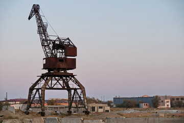 Aralsk, Kazakhstan - 10.04.2020 : The old metal structure of the destroyed port on the Aral Sea