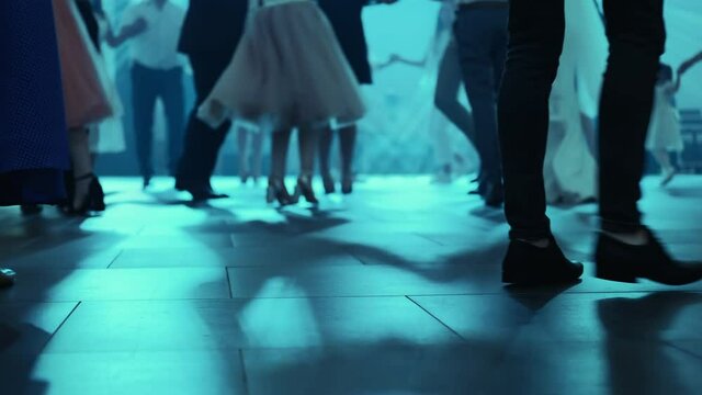Guests dancing moldavian national dance - Hora at a wedding. Stage lights