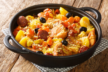 Galinha a Portuguesa traditional Chicken Dish From Macau close up in the pan on the table. Horizontal