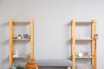 Modern TV stand with shelves and decor near light wall