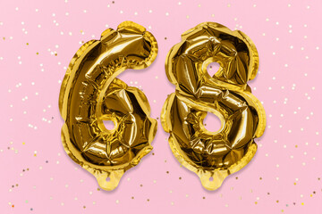 The number of the balloon made of golden foil, the number sixty-eight on a pink background with sequins. Birthday greeting card with inscription 68. Numerical digit, Celebration event, template.