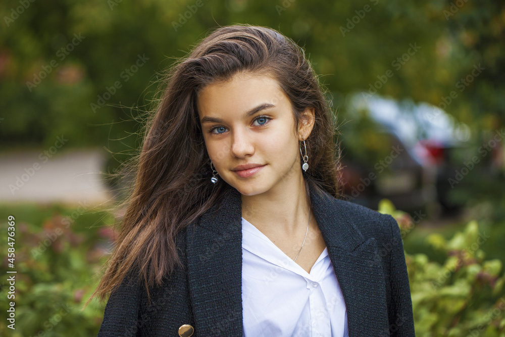 Wall mural Portrait of a young beautiful brunette  girl in summer park