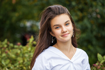 Fototapeta premium Young teenage brunette girl in white shirt
