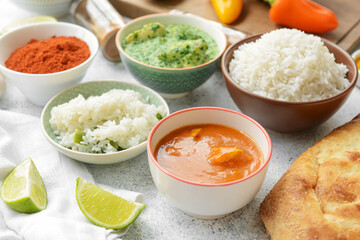Traditional Indian food and spices on light background