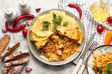 Plates with tasty Shah Pilaf, bread and vegetables on light background