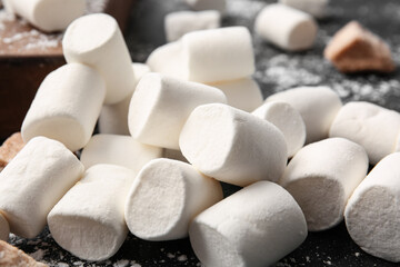 Tasty marshmallows on dark background, closeup
