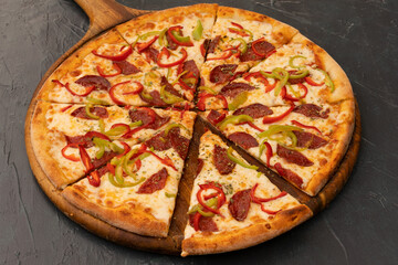 Delicious mixed ingredients Italian pizza, red and green pepper slices and sucuk, pepperoni.