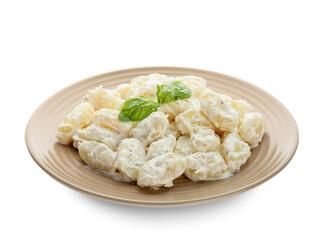 Plate of delicious gnocchi with creamy sauce on white background