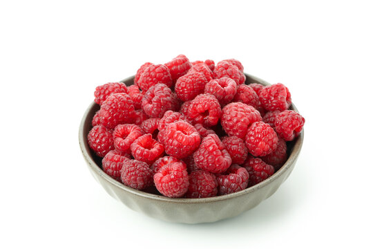 Red juicy raspberries in bowl, isolated on white background