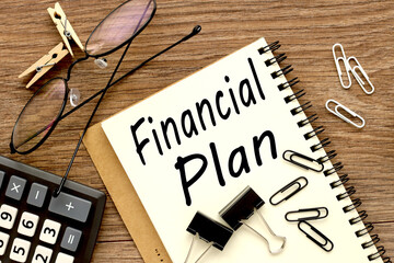 financial plan. Top view of office wood table. view of an open notebook. with place for text. calculator, glasses, financial planning and work concept.