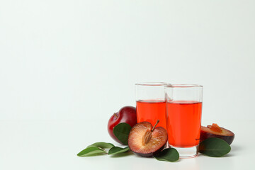 Plum brandy shots and ingredients on white background