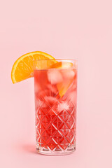 Glass of tasty Negroni cocktail on color background