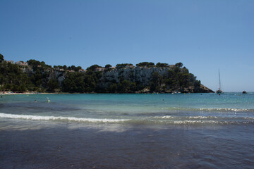 small bay, sea and blue sky of a Menorca beach with transparent waters of the Mediterranean Sea, Balearic Islands, Spain