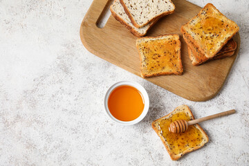 Delicious toasted bread with honey on light background