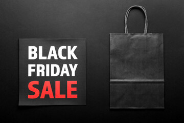 Shopping bag and card with text BLACK FRIDAY SALE on dark background