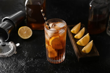 Glass of tasty Long Island iced tea on dark background