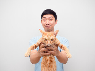 Young man showing domestic cat orange color in his hand white background