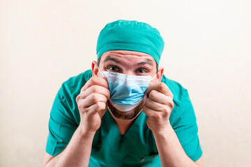 Fototapeta na wymiar Funny doctor in a cap and a medical mask.