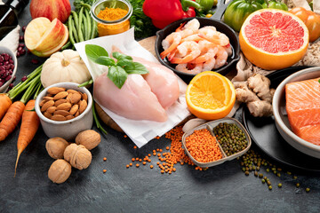Healthy food assortment on dark background.
