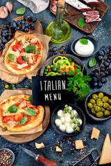 Italian food assortment on dark background.