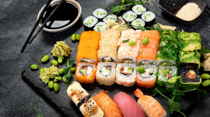 Sushi and roll set on dark background. Traditional food concept.