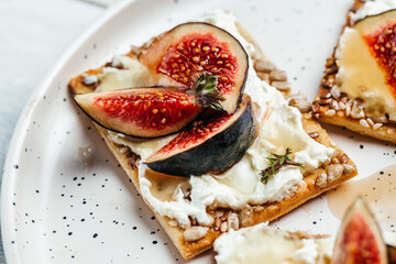 Homemade toast with wholemeal cookies with cream-cheese and fresh figs. top view