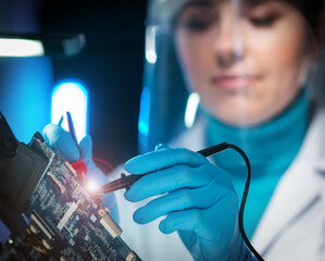 Workplace of young woman in modern microelectronics manufacturing lab. Engineer works in a modern...