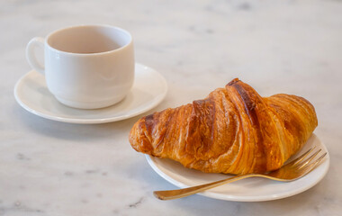 The Homemade Croissants with a cup of coffee on the table