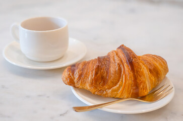 The Homemade Croissants with a cup of coffee on the table
