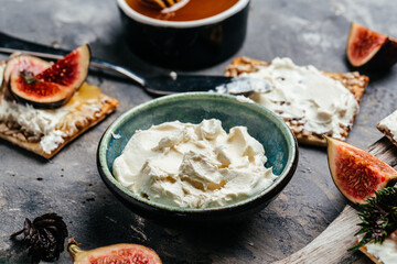 Cream Cheese. Bowl of philadelphia cream cheese and fresh figs. Food recipe background. Close up