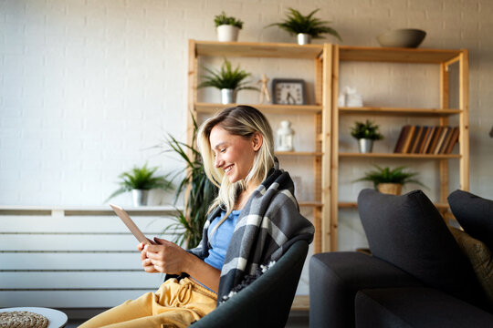 Happy young woman using tablet pc in loft apartment